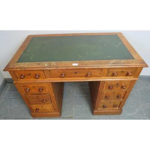 775 - A late Victorian light oak pedestal desk of small proportions, housing an array of seven graduated d... 