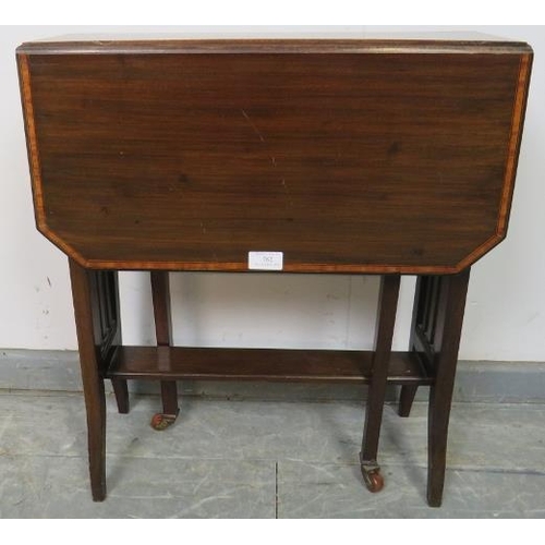 782 - An Edwardian mahogany Sutherland table, with crossbanded inlay, on square supports with ceramic cast... 