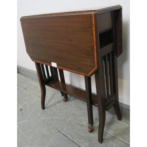 782 - An Edwardian mahogany Sutherland table, with crossbanded inlay, on square supports with ceramic cast... 