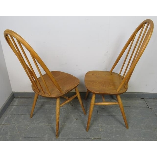 785 - Three mid-century blond elm and beech Windsor Quaker dining chairs by Ercol, on canted supports with... 