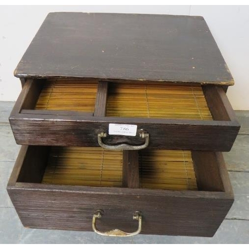 786 - A vintage Japanese miniature ebonised tansu chest, of two bamboo-lined drawers with steel drop handl... 