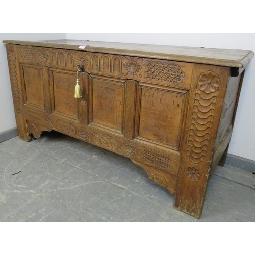 792 - A large 17th century medium oak panelled coffer, the front featuring chisel carved frieze with carve... 