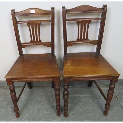 795 - A pair of Edwardian hall chairs with pierced back splats, on tapering turned supports with side stre... 