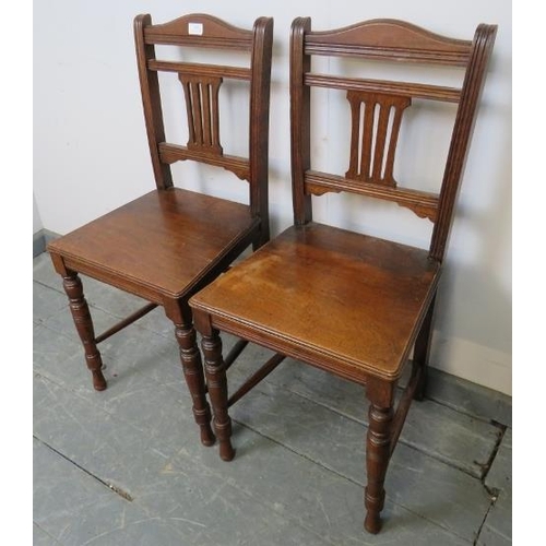 795 - A pair of Edwardian hall chairs with pierced back splats, on tapering turned supports with side stre... 