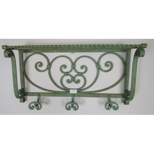 800 - A vintage wrought iron wall hanging shelf painted green, featuring scrolled decoration, with three c... 