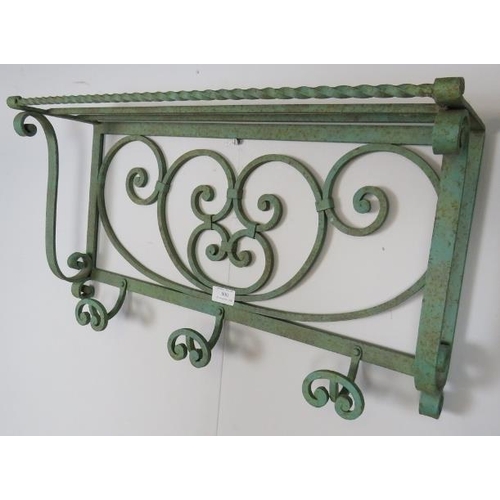 800 - A vintage wrought iron wall hanging shelf painted green, featuring scrolled decoration, with three c... 