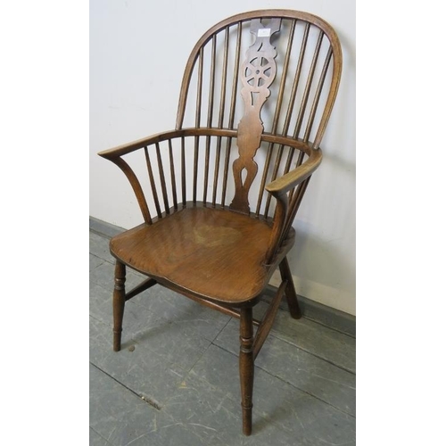 803 - A 19th century oak and elm Windsor wheelback chair, on turned canted supports with an ‘H’ stretcher.... 