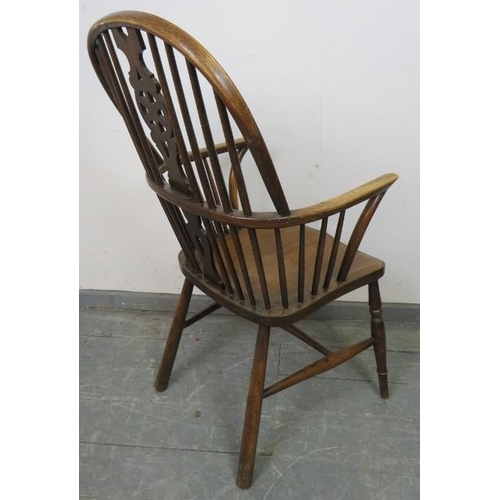 803 - A 19th century oak and elm Windsor wheelback chair, on turned canted supports with an ‘H’ stretcher.... 