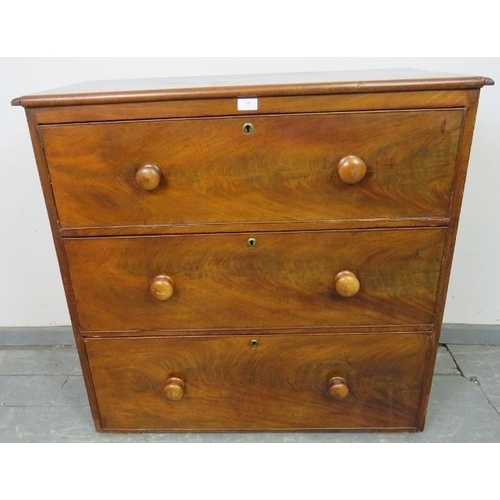 806 - A Victorian mahogany chest of three long cock-beaded drawers with the original turned wooden knob ha... 