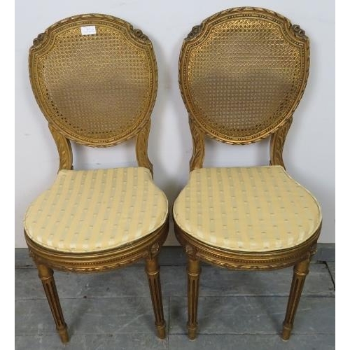 811 - A pair of vintage French giltwood opera seats with bergère back and seat panels, featuring carved fo... 