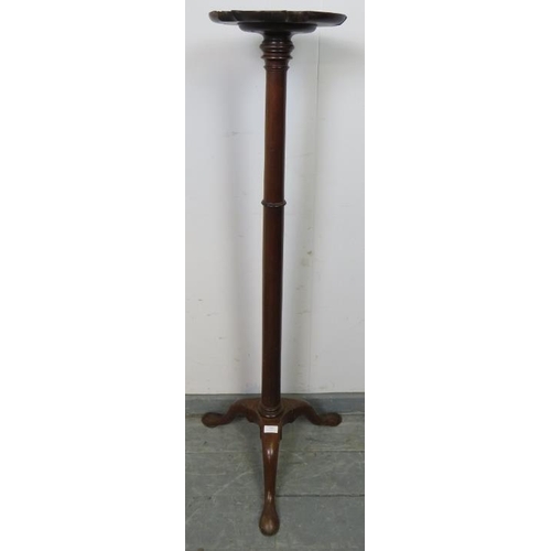 813 - A 19th century mahogany torchere with piecrust edge, over a tapering plain column, the outswept trip... 