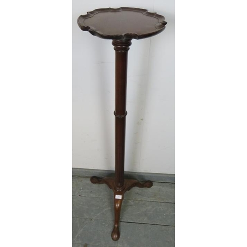 813 - A 19th century mahogany torchere with piecrust edge, over a tapering plain column, the outswept trip... 