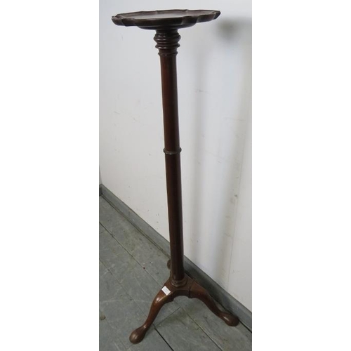 813 - A 19th century mahogany torchere with piecrust edge, over a tapering plain column, the outswept trip... 