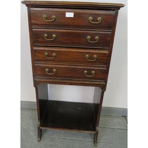 819 - An Edwardian mahogany music cabinet, the four long drawers with hinged fronts and gilt brass handles... 