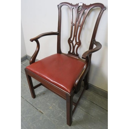 824 - A Georgian mahogany elbow chair with carved and pierced back splat in the Chippendale taste and red ... 