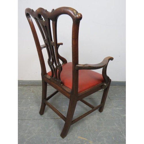 824 - A Georgian mahogany elbow chair with carved and pierced back splat in the Chippendale taste and red ... 