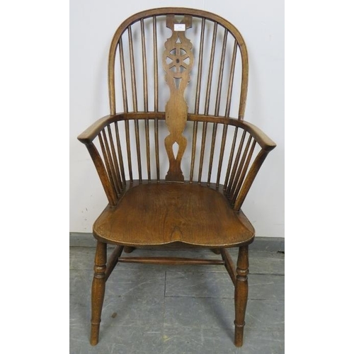 826 - A 19th century elm and oak Windsor wheelback chair, on canted supports with an ‘H’ stretcher. 
Condi... 