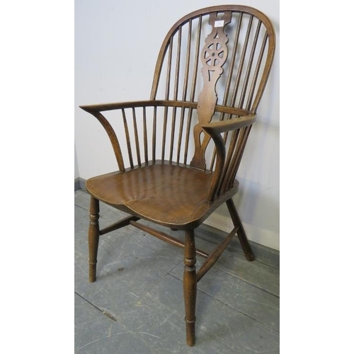 826 - A 19th century elm and oak Windsor wheelback chair, on canted supports with an ‘H’ stretcher. 
Condi... 