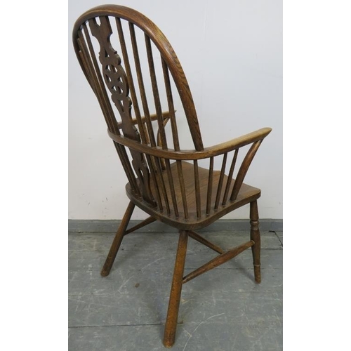 826 - A 19th century elm and oak Windsor wheelback chair, on canted supports with an ‘H’ stretcher. 
Condi... 