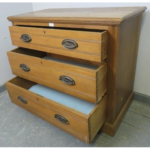 832 - A small Edwardian satin walnut chest of three long drawers with pressed brass handles, on a plinth b... 