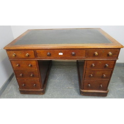 833 - A Victorian mahogany pedestal desk with green inset leather writing surface, housing nine graduated ... 