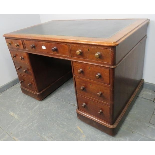 833 - A Victorian mahogany pedestal desk with green inset leather writing surface, housing nine graduated ... 