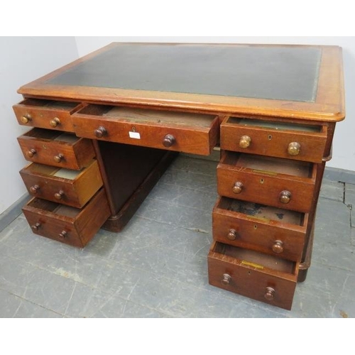 833 - A Victorian mahogany pedestal desk with green inset leather writing surface, housing nine graduated ... 