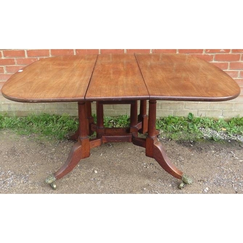 836 - A 19th century mahogany drop-leaf dining table on six turned supports terminating on outswept feet w... 