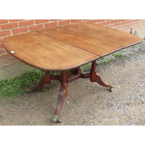 836 - A 19th century mahogany drop-leaf dining table on six turned supports terminating on outswept feet w... 