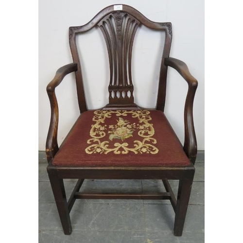 838 - A Georgian mahogany elbow chair in the manner of Hepplewhite, with carved and pierced back splat and... 