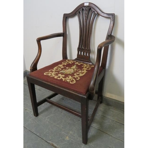 838 - A Georgian mahogany elbow chair in the manner of Hepplewhite, with carved and pierced back splat and... 