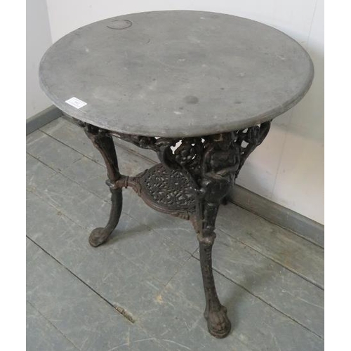 841 - A 19th century circular Britannia table, the slate top over an ornate cast iron base, on splayed sup... 