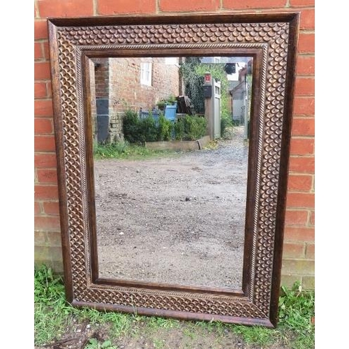 846 - A contemporary bevelled wall mirror in an intricately tooled metal surround. 
Condition report: No i... 