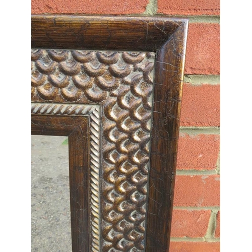 846 - A contemporary bevelled wall mirror in an intricately tooled metal surround. 
Condition report: No i... 