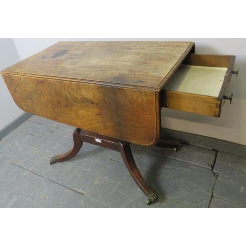 847 - A Regency Period mahogany drop leaf supper table, with single drawer and dummy drawer, on a square p... 