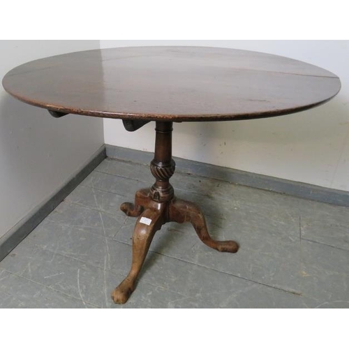 848 - A Georgian mahogany birdcage table, on a tapering carved pedestal with splayed tripod supports. 
Con... 