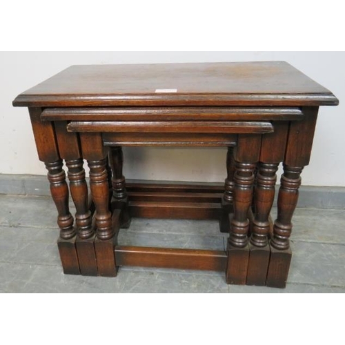 849 - A nest of three vintage rectangular solid oak nesting tables, on baluster turned supports with stret... 