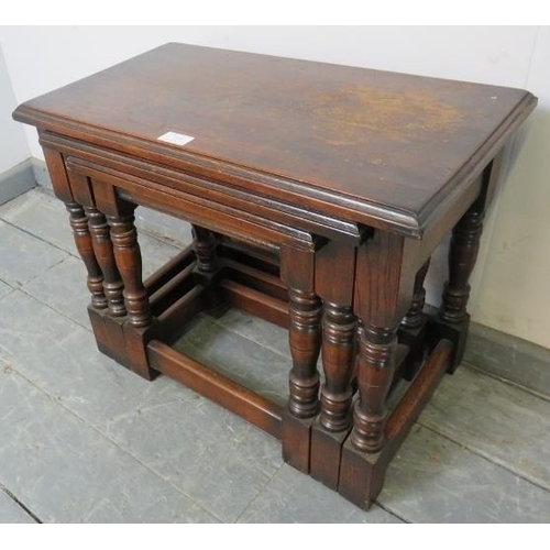 849 - A nest of three vintage rectangular solid oak nesting tables, on baluster turned supports with stret... 