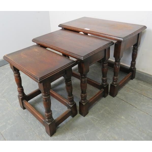 849 - A nest of three vintage rectangular solid oak nesting tables, on baluster turned supports with stret... 