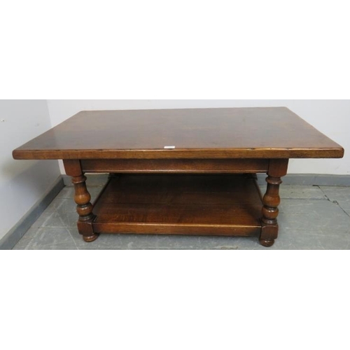 852 - A vintage heavy oak two-tier rectangular coffee table, on baluster turned supports with bun feet. 
C... 