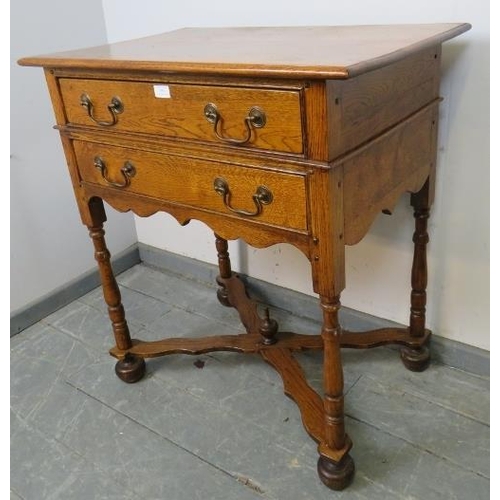 856 - A vintage golden oak side table of two long drawers with swan-neck handles, on baluster turned suppo... 