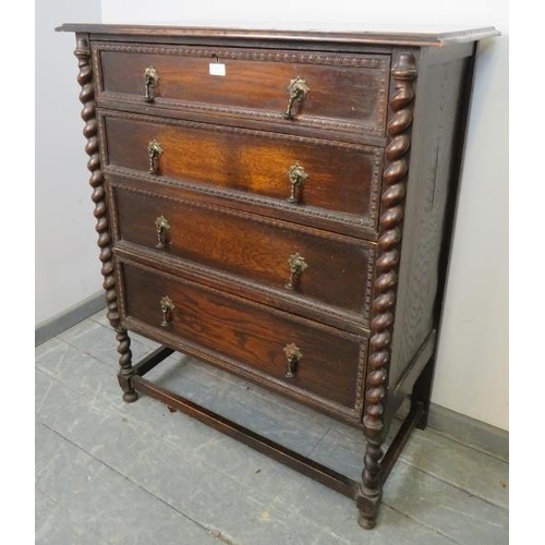 857 - A 1920s oak Jacobean Revival chest of four graduated drawers with brass drop handles and egg and dar... 