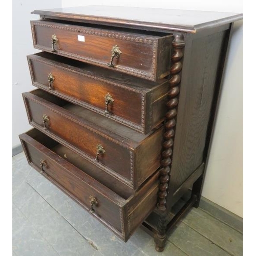 857 - A 1920s oak Jacobean Revival chest of four graduated drawers with brass drop handles and egg and dar... 