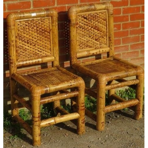 860 - A pair of vintage bamboo side chairs, with woven backrests and seats, on chunky bamboo supports.
Con... 