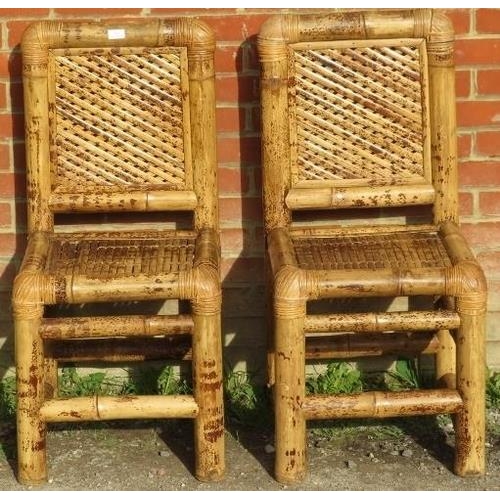 860 - A pair of vintage bamboo side chairs, with woven backrests and seats, on chunky bamboo supports.
Con... 