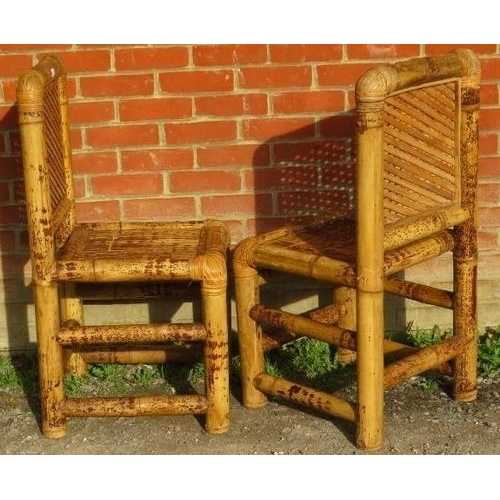 860 - A pair of vintage bamboo side chairs, with woven backrests and seats, on chunky bamboo supports.
Con... 