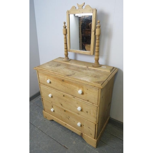 861 - A Victorian stripped pine dressing chest, the swing mirror on turned uprights with finials, above th... 