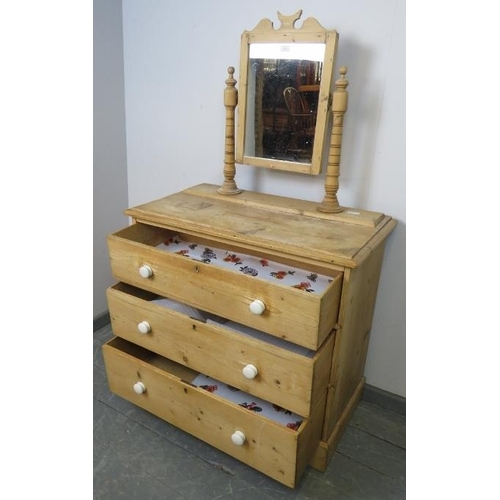 861 - A Victorian stripped pine dressing chest, the swing mirror on turned uprights with finials, above th... 