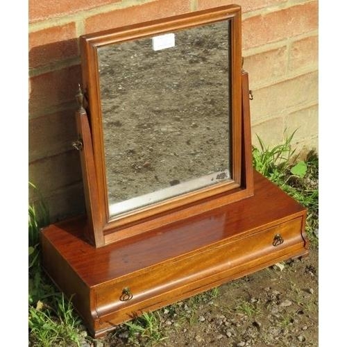 867 - A Georgian mahogany swing vanity mirror with brass finials, above a box base with single drawer, on ... 