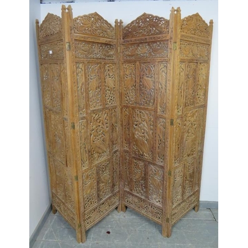 871 - A vintage hardwood Eastern four-section folding screen, with carved and pierced decoration depicting... 